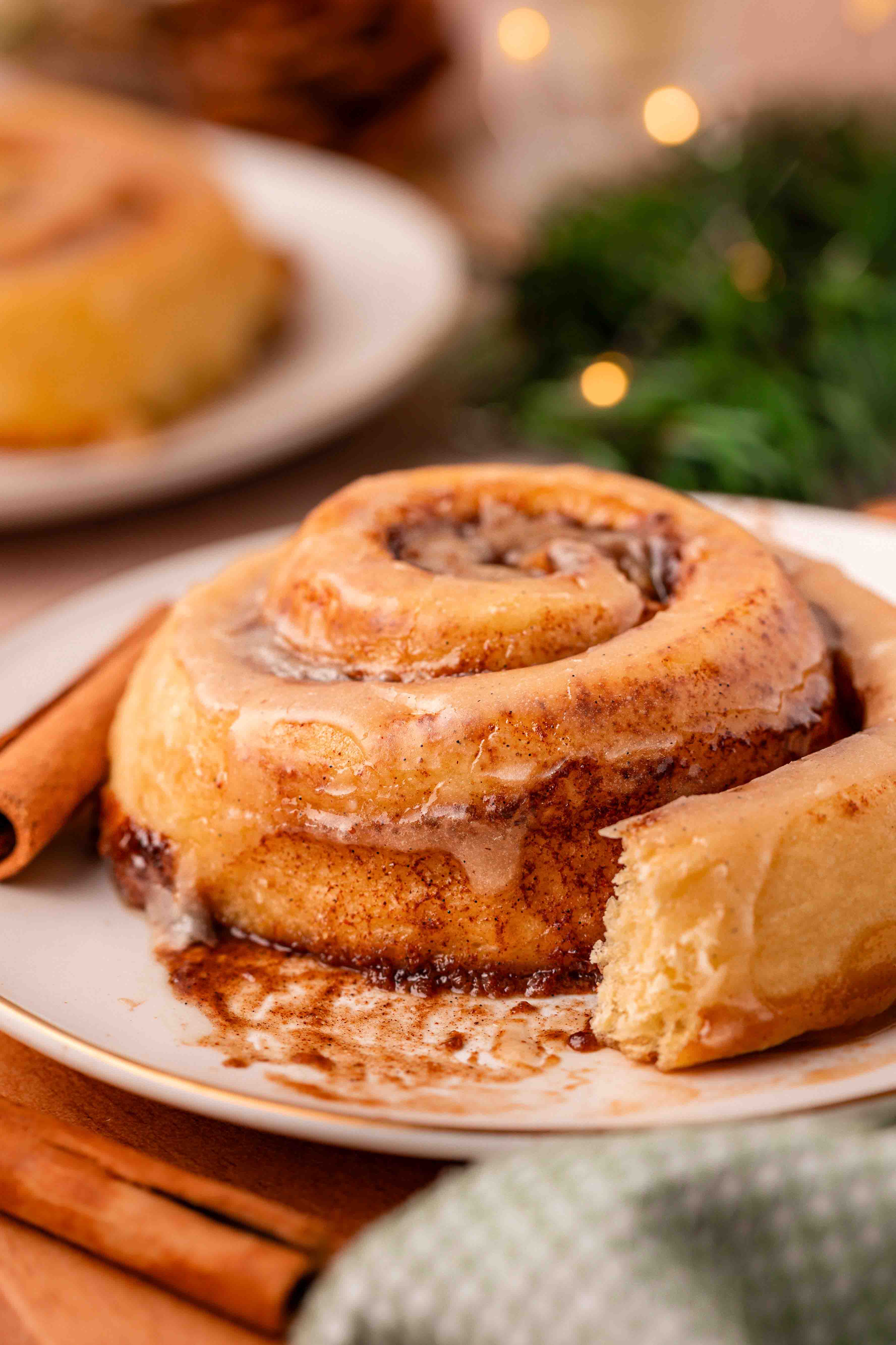 Eggnog cinnamon rolls on a white plate.