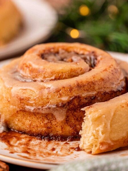 Eggnog cinnamon rolls on a white plate.