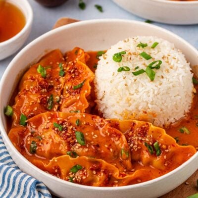 A white bowl with white rice and viral baked dumplings in it.