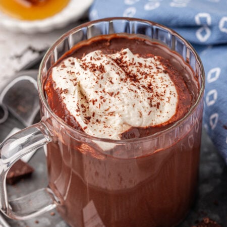 A mug of Earl Grey Hot Chocolate in a clear glass mug.
