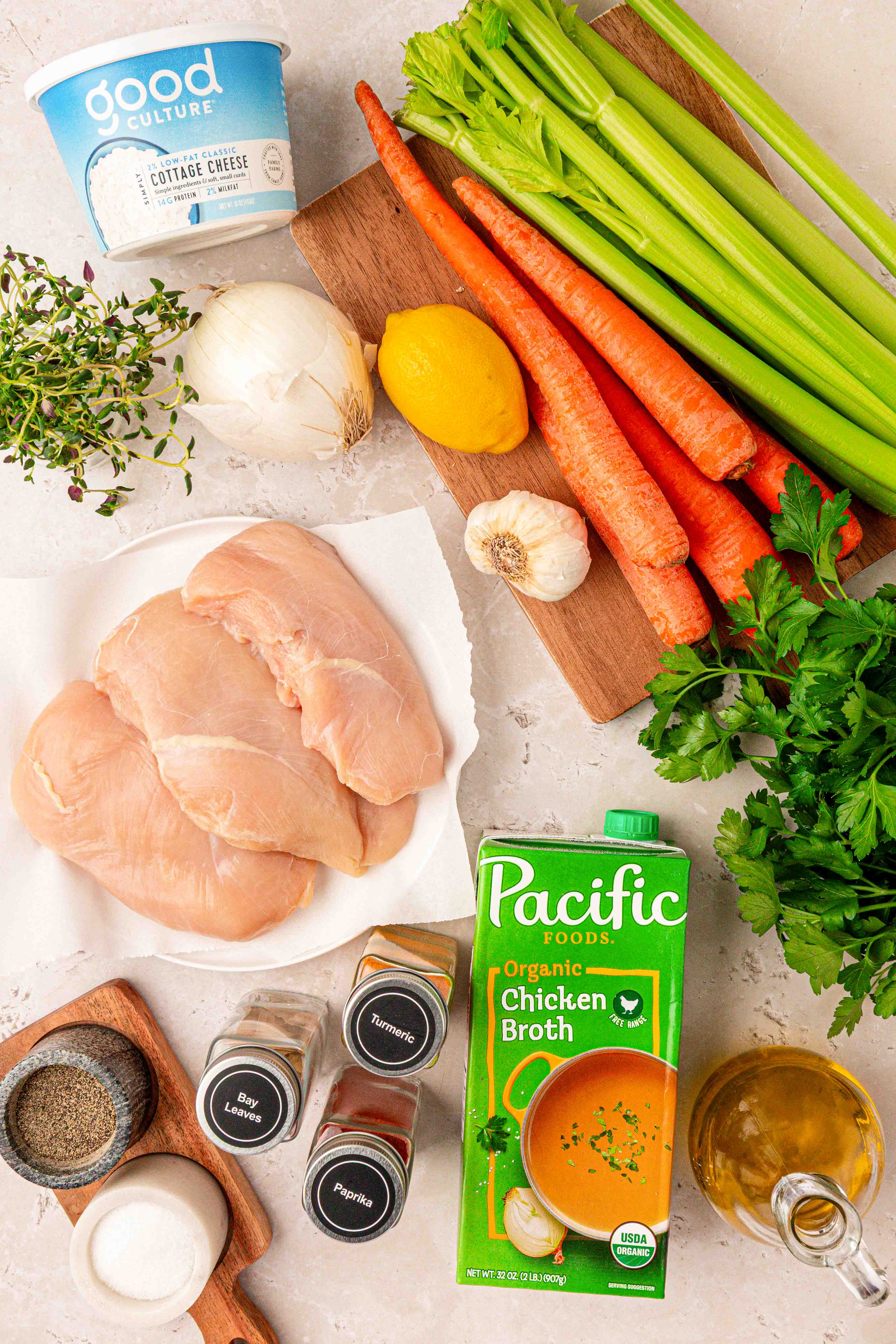 Ingredients to make chicken soup chicken salad on a table.