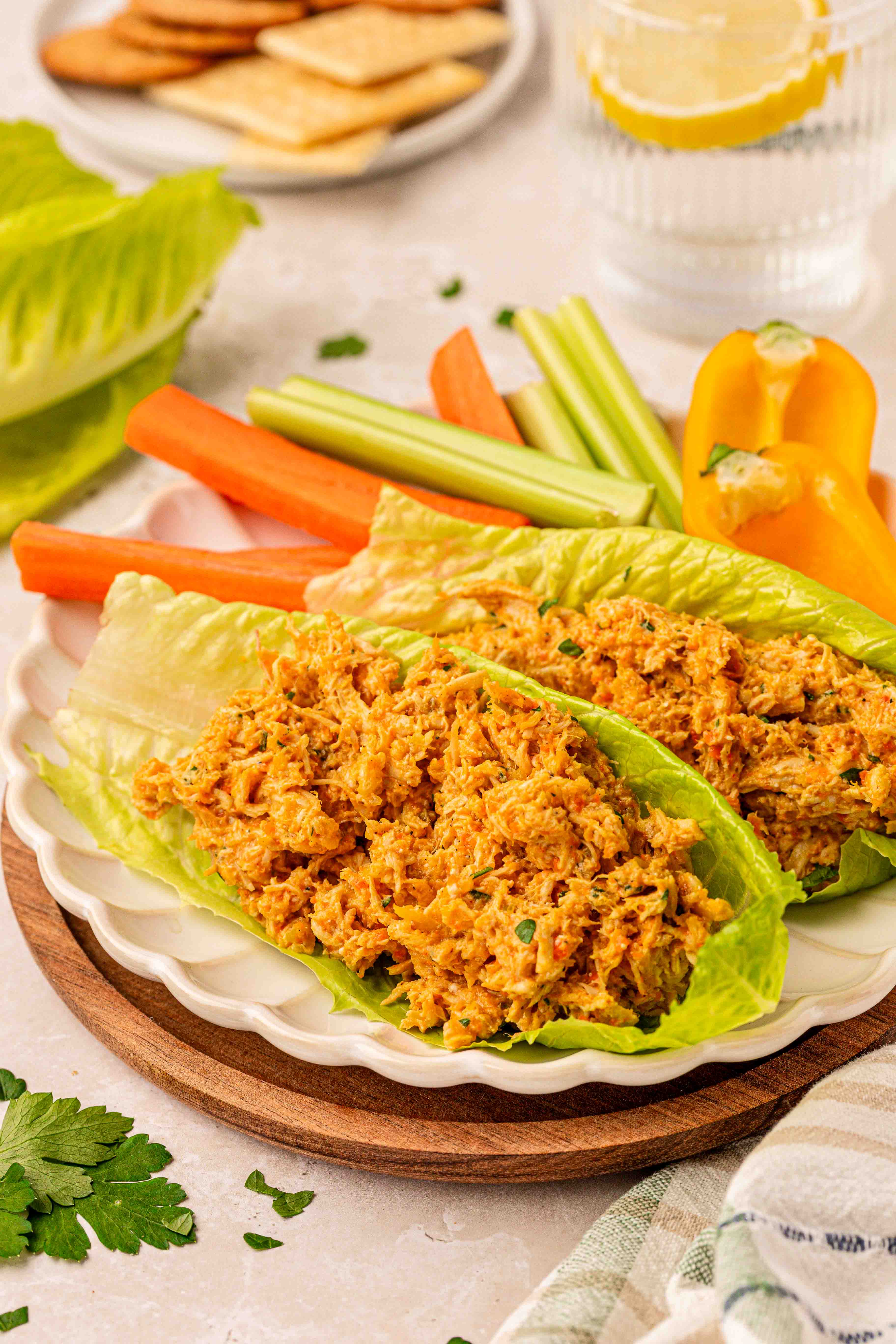 Chicken Soup Chicken Salad in romaine lettuce leaves on a scalloped plate.