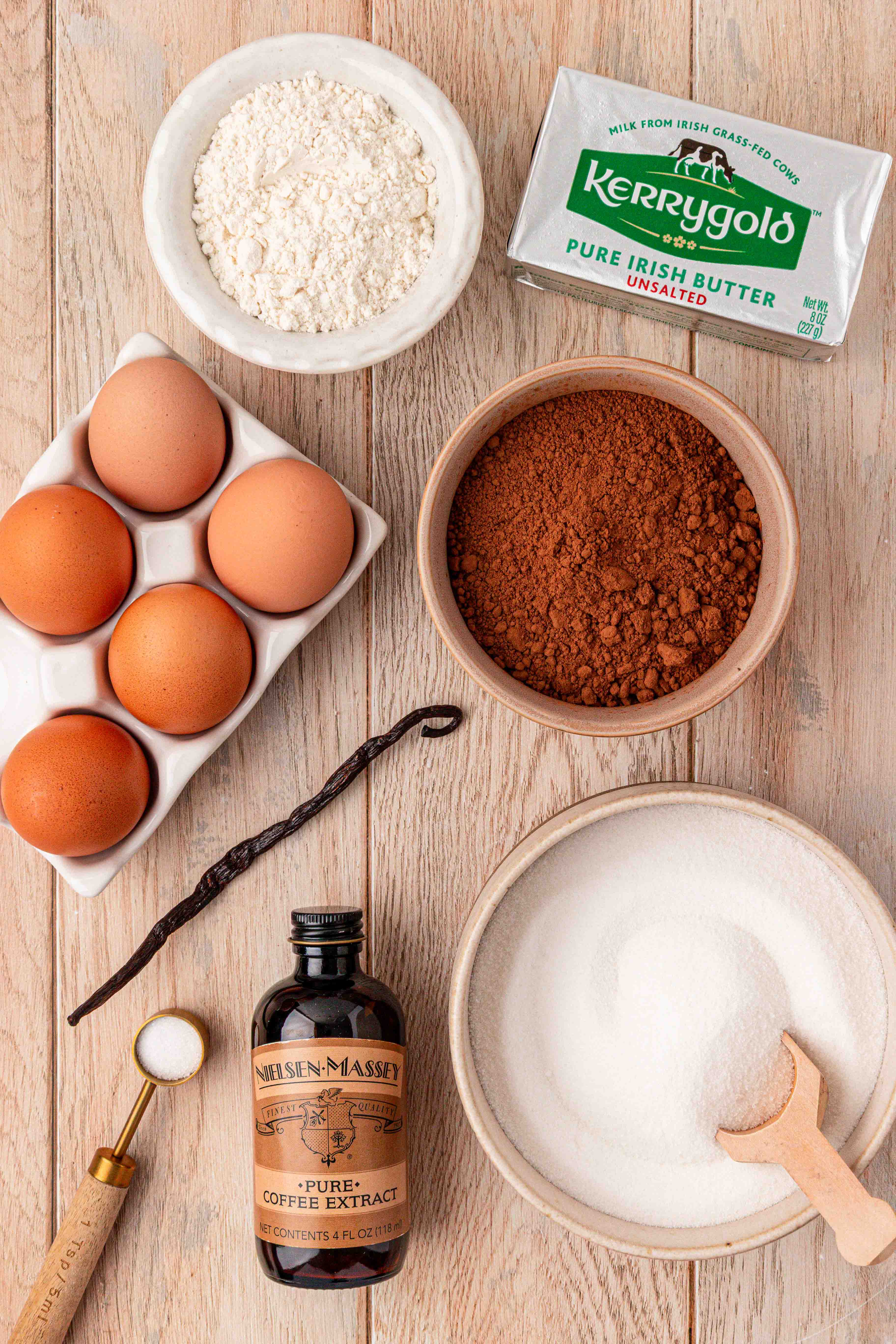 Overhead photo of ingredients to make brownie pudding on a light wooden table.