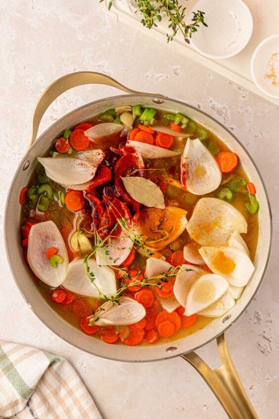 Veggies and herbs in a pan.