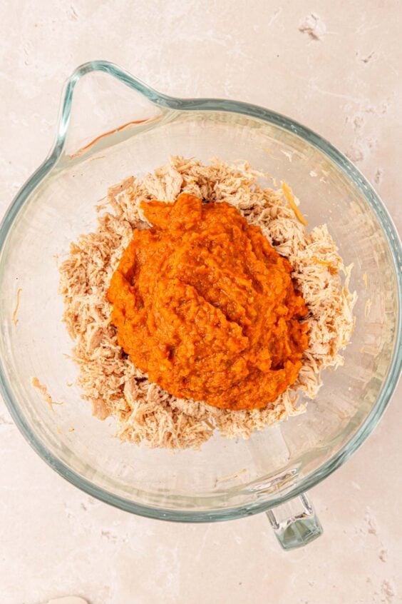 Pureed veggies with shredded chicken in a bowl.