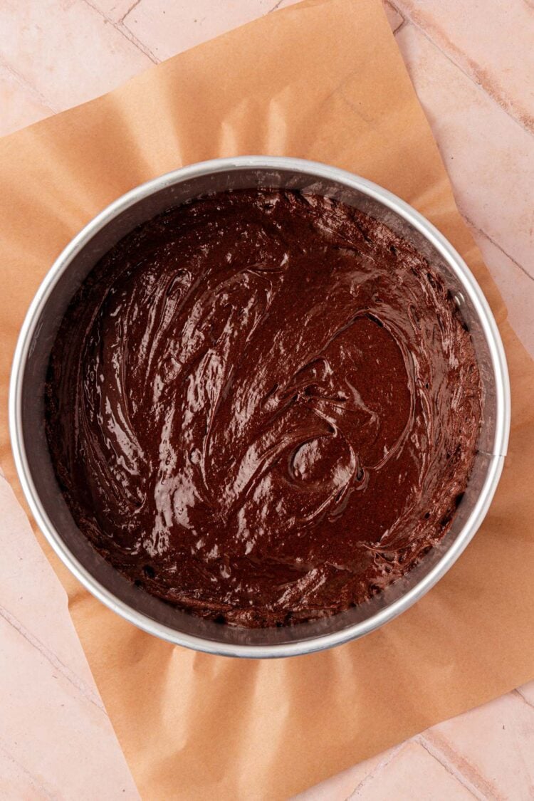Chocolate cake batter in a springform pan.