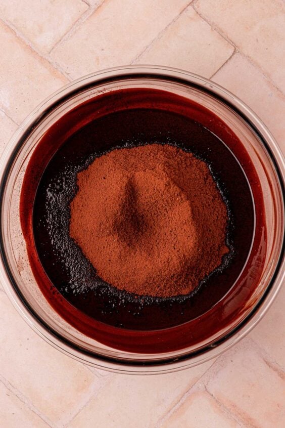 Cocoa powder dished into melted butter and chocolate.