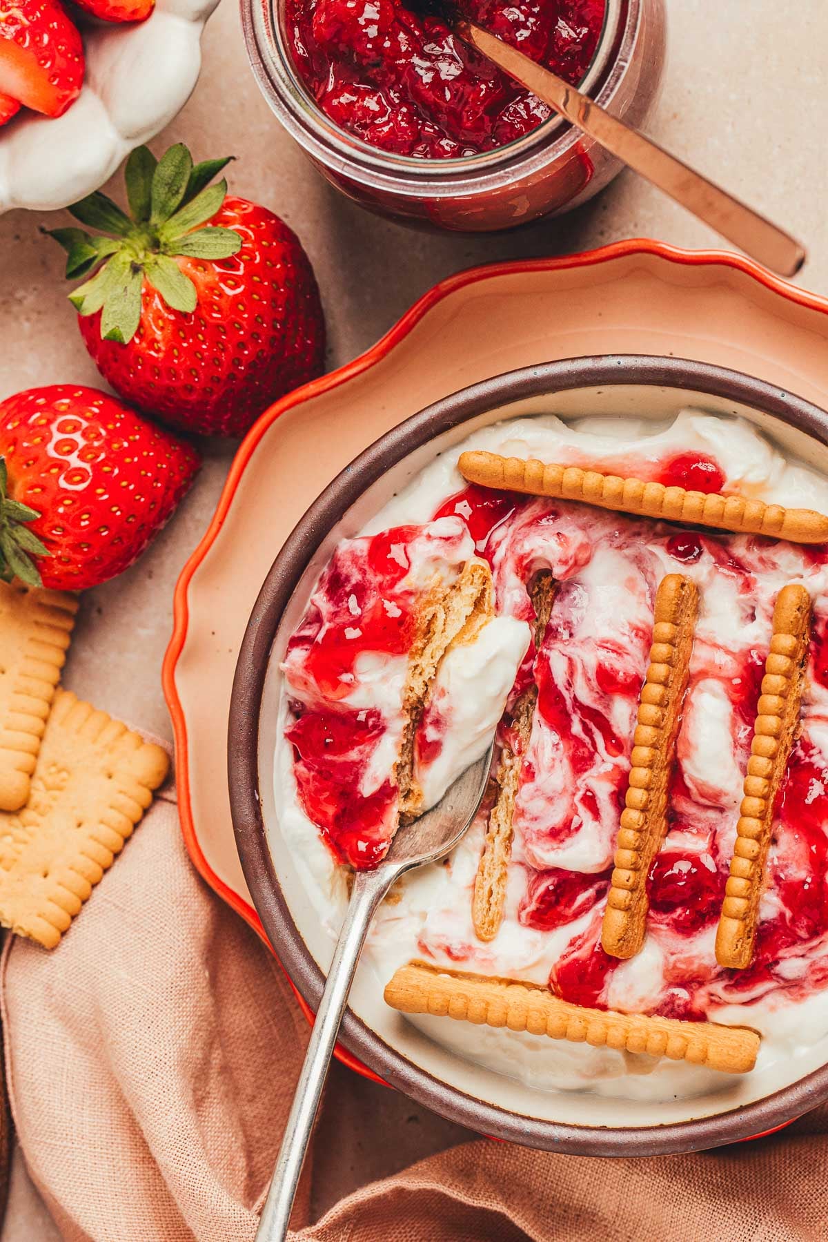 Overhead photo of viral Japanese cheesecake with strawberry and biscuits.