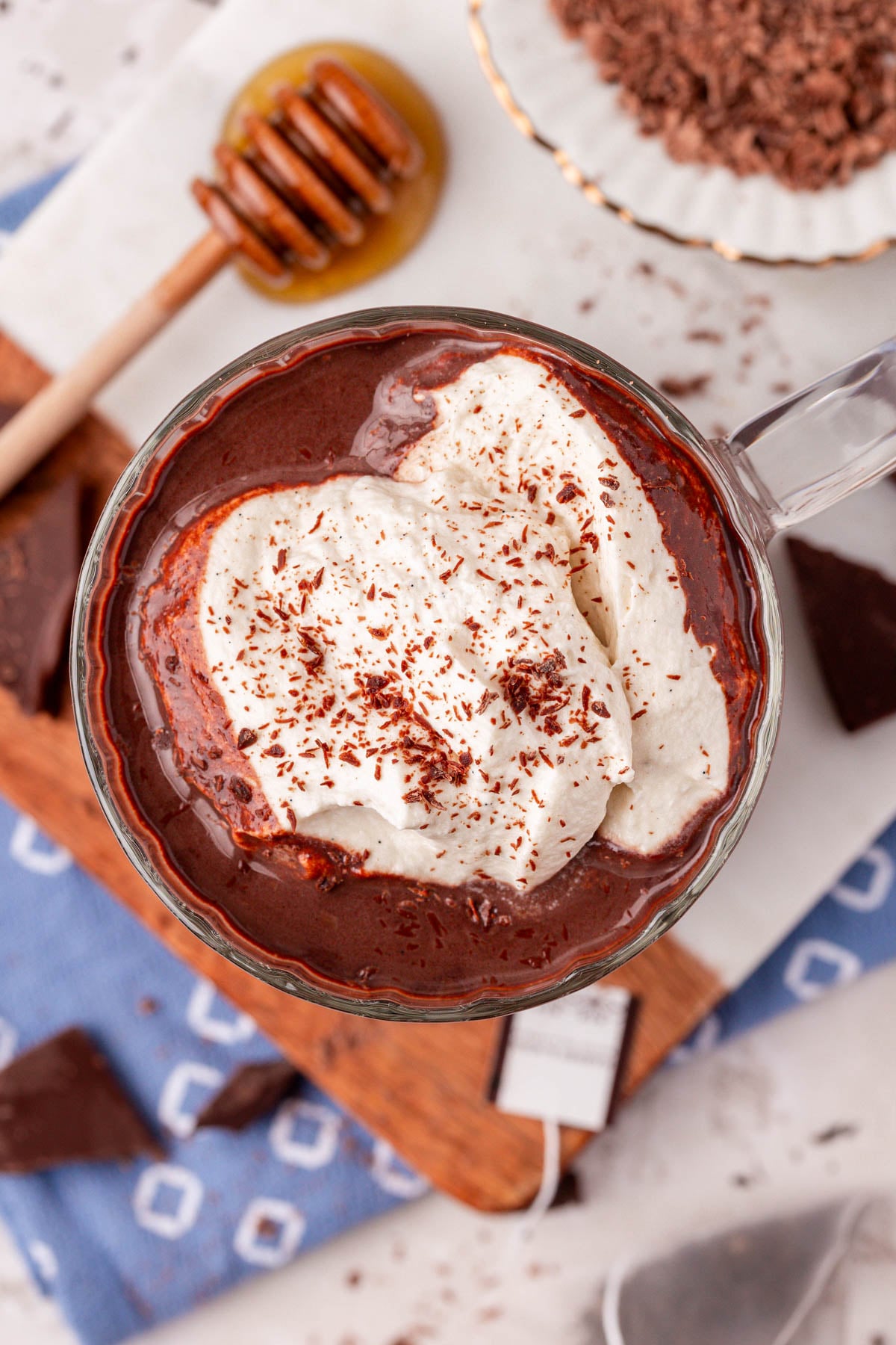 Overhead of a mug of Earl Grey hot chocolate topped with whipped cream.