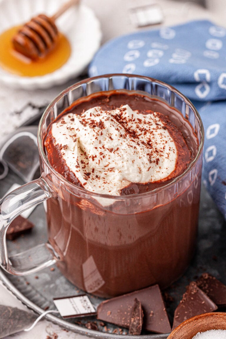 A mug of Earl Grey Hot Chocolate in a clear glass mug.