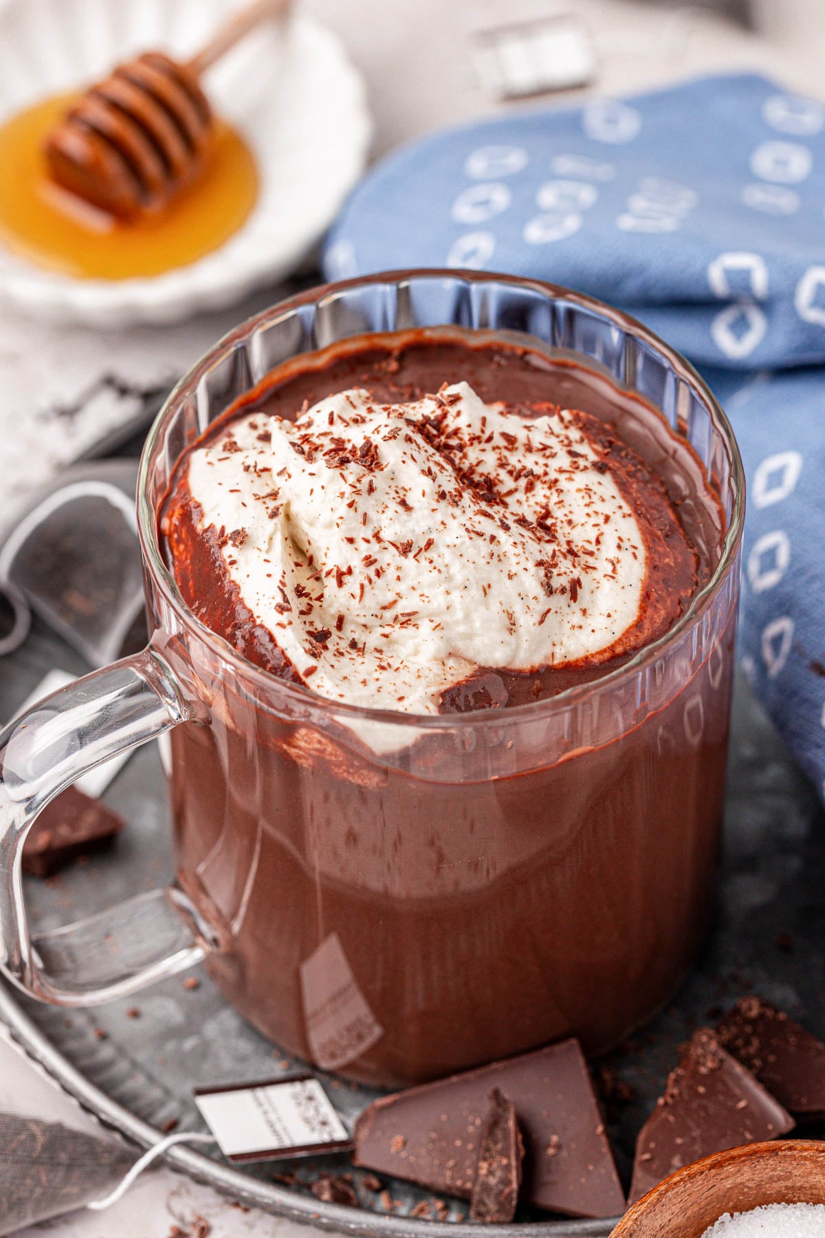 A mug of Earl Grey Hot Chocolate in a clear glass mug.