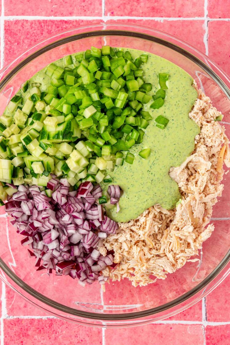 Ingredients for green goddess chicken salad in a glass mixing bowl.
