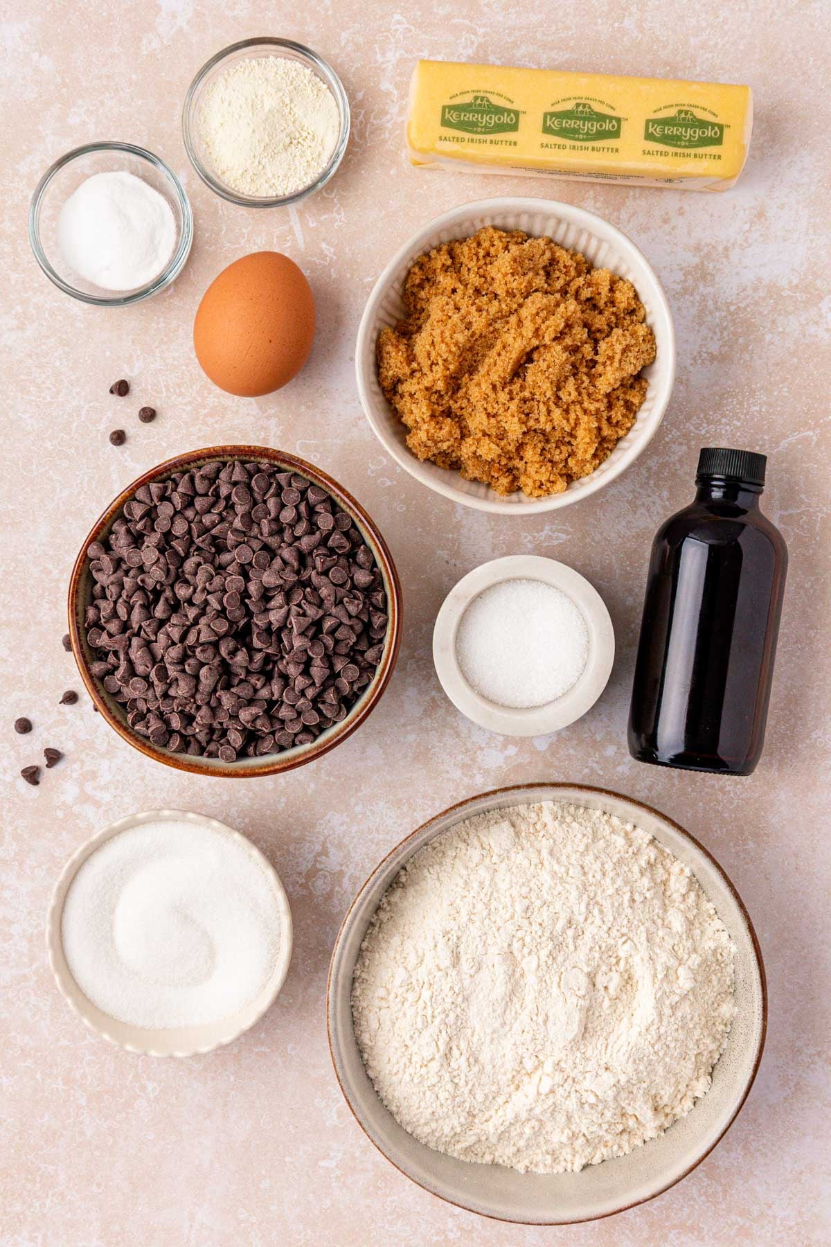 Ingredients to make chocolate chip cookies on a table.