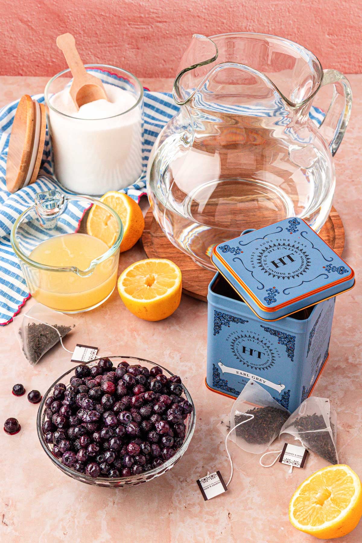 Ingredients to make blueberry iced tea on a table.