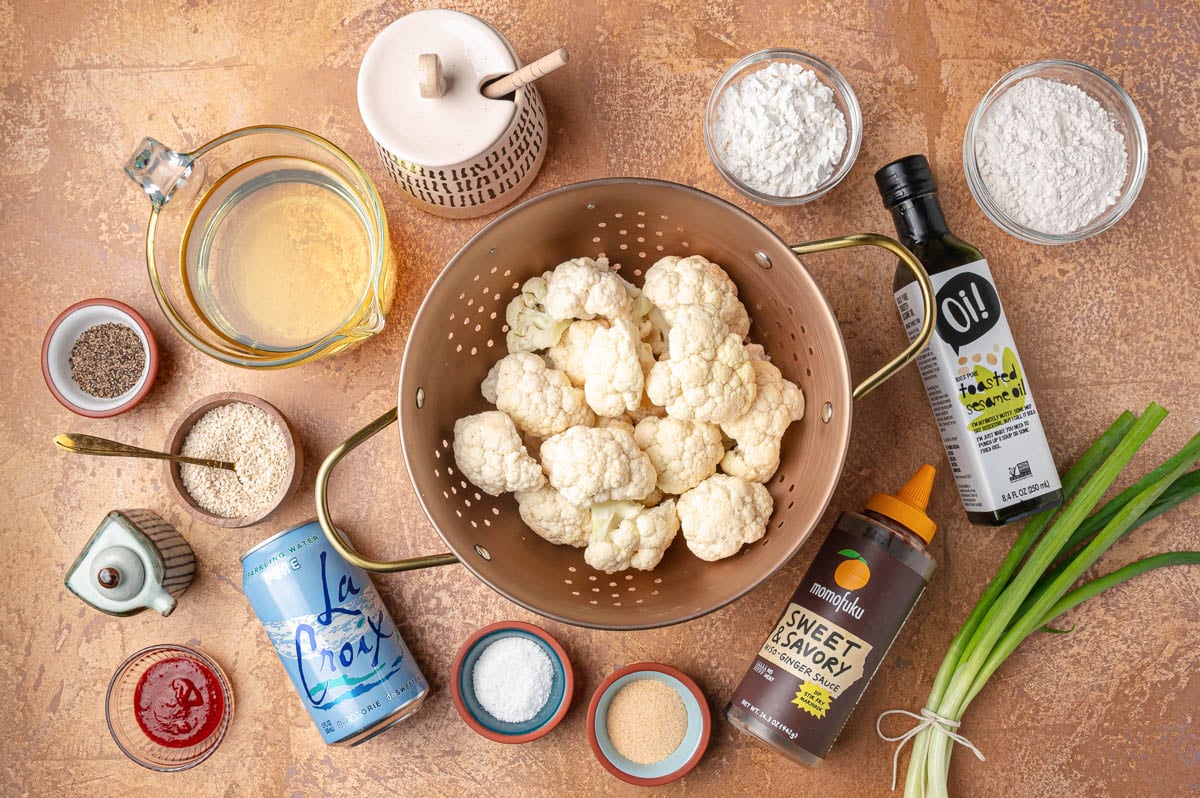 Ingredients to make Korean Fried Cauliflower on a brown table.