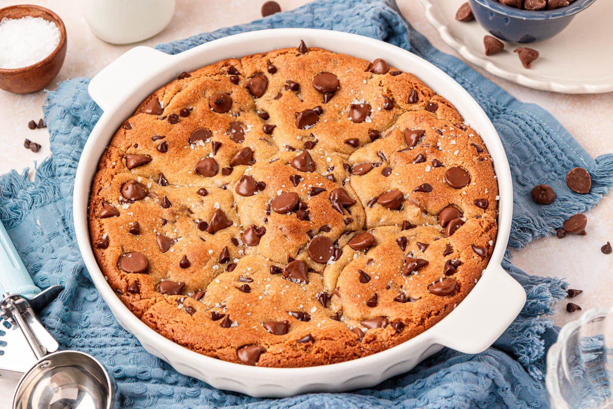 A pie dish filled with baked scoopable chocolate chip cookies.