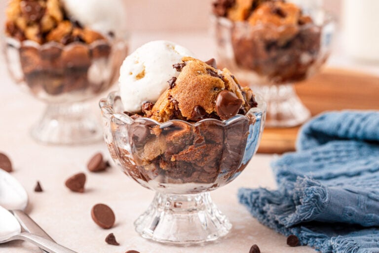 Three ice cream dishes filled with scoopable chocolate chip cookies and vanilla ice cream.