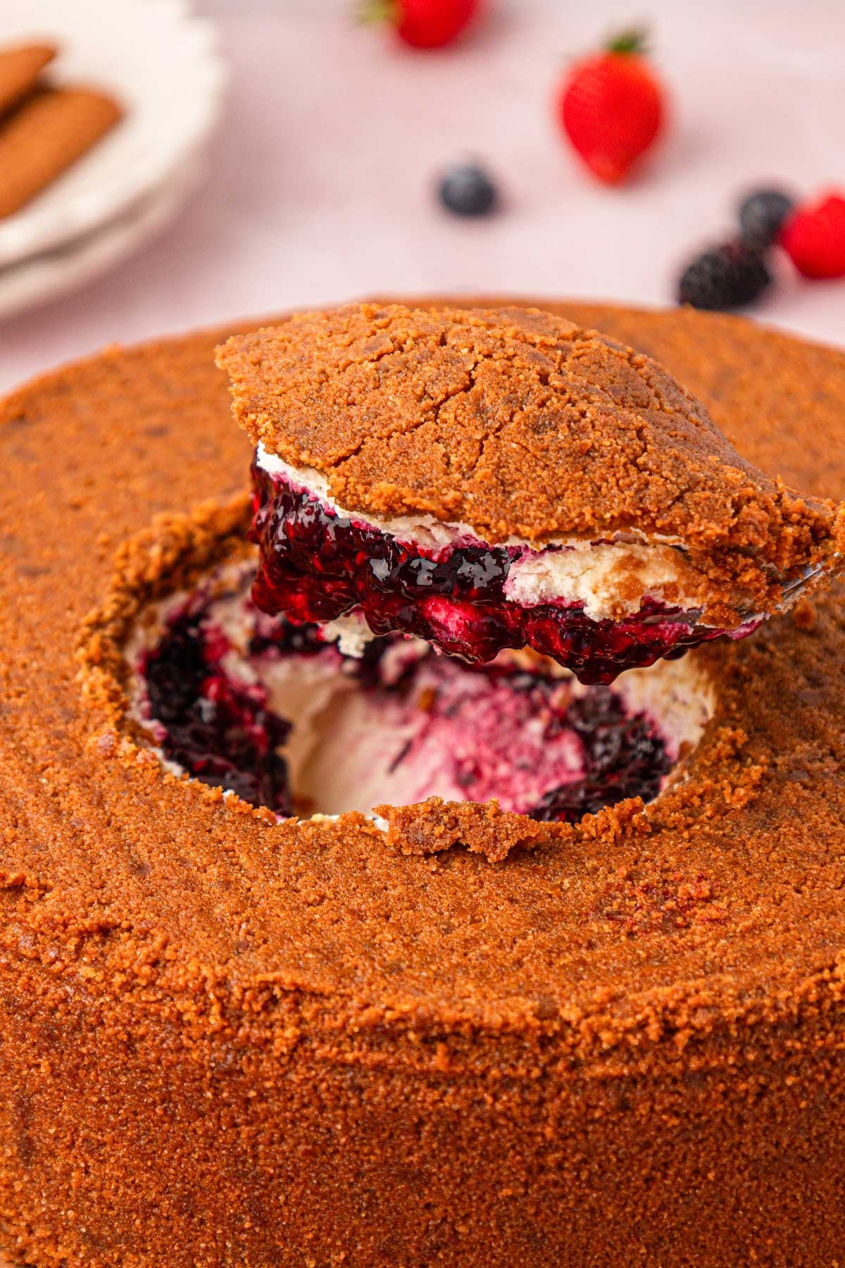 A scoop being taken out of the center of an upside down no bake cheesecake.