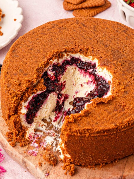Close up of a viral upside down cheesecake with berry filling and biscoff crust.