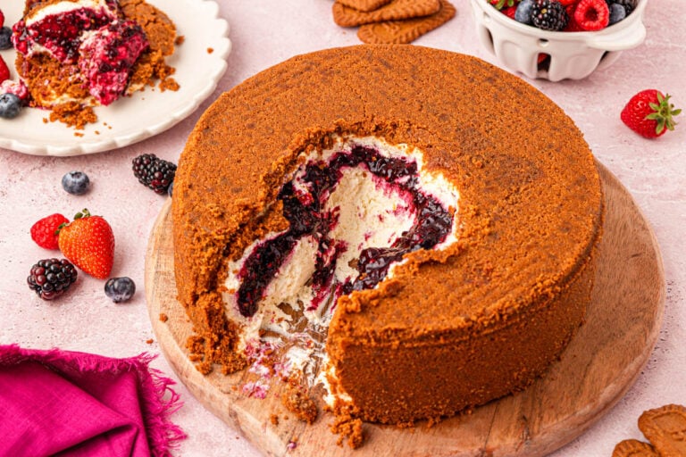 Close up of a viral upside down cheesecake with berry filling and biscoff crust.